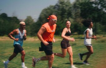 Team marathon running event launches in London 4 people running on grass