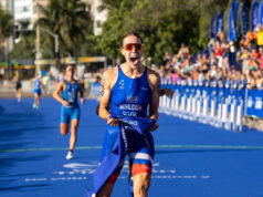 Legg and Michalickova claim maiden World Cup glory in Rio Female athlete in blue crosses finish line. She's holding the blue finish tape in one hand, and yelling in delight