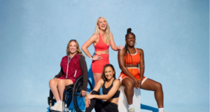 4 women pose for a photo in theiir sports kit. One woman is in a wheelchair.