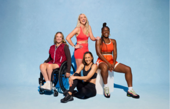 PhD Nutrition champions wellness for women 4 women pose for a photo in theiir sports kit. One woman is in a wheelchair.