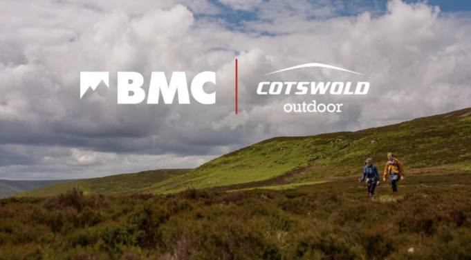 BMC Two people walking on a green hillside
