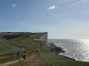 £600,000 raised at South Coast Ultra Runners on the edge of dramatic white chalk cliffs. The sea is to the right.