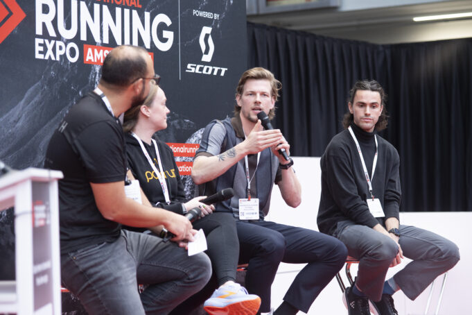 4 speakers sit on a stage chatting
