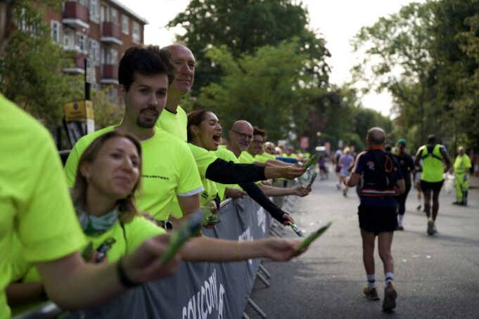 Run Shoreditch Supporters in bright yellow neon t-shirts line the streets full of runners