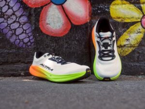 Road shoes against a black wall decorated with colourful flowers