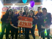 Halloween hike through London’s spooky spots A group of runners in Halloween fancy dress hold a sign saying 42km