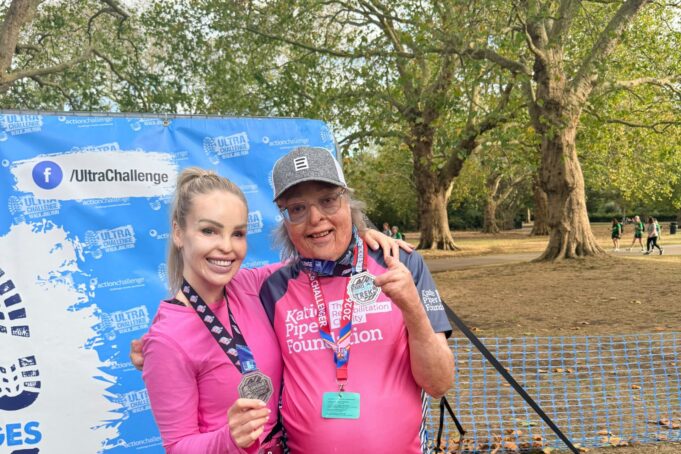 Katie Piper A man and woman pose in pink tshirts with medals
