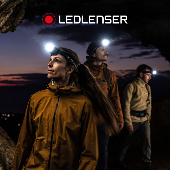 3 people wearing headtorches at night