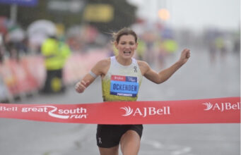 Call for Championship Entries – Great South Run Woman runs hard through red tape of a finish line