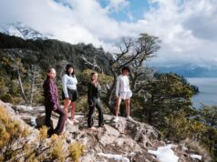 Chica unveils Layers for Autumn 4 women on a rocky outcrop by the sea wearing activewear
