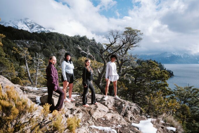 CHICA 4 women on a rocky outcrop by the sea wearing activewear