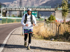 British runner Jack Jarvis crosses China on foot Man runs along side of a road with mountains in the background