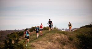 5 runners run over a small hiillock