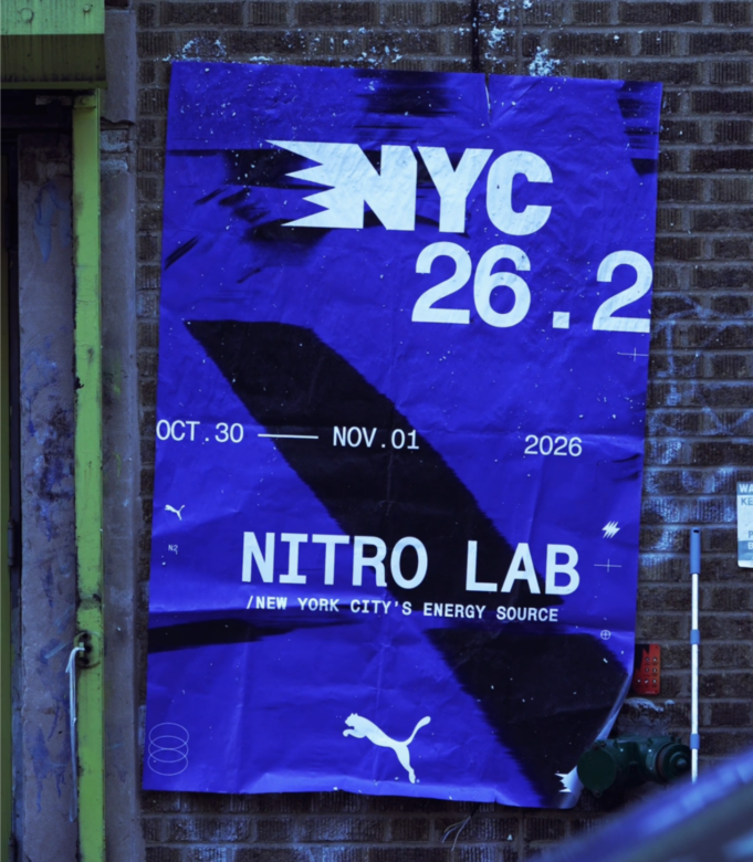 NYC NITRO LAB A deep blue poster against a brick wall reads NYC 26.2 Nitro Lab