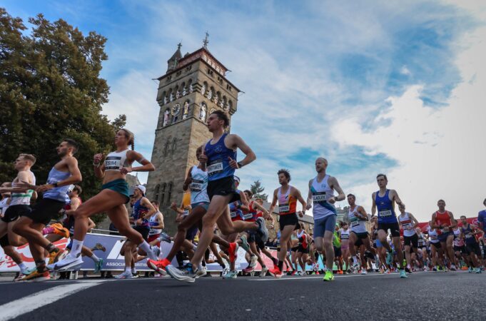 OYSHO Cardiff Half Marathon 2025, Image Credit Huw Fairclough|Run4Wales A crowd of road runners running fast past a tower