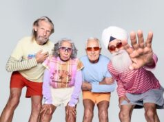 Britain’s oldest running team. Combined age: 321 4 runners in bright clothes, with grey hair, pose for the camera.
